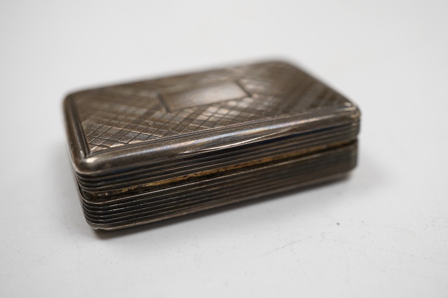 An early Victorian silver rectangular vinaigrette, with engraved chequered decoration, by William Simpson. Birmingham, 1836, 39mm, together with a late Victorian silver vesta case.